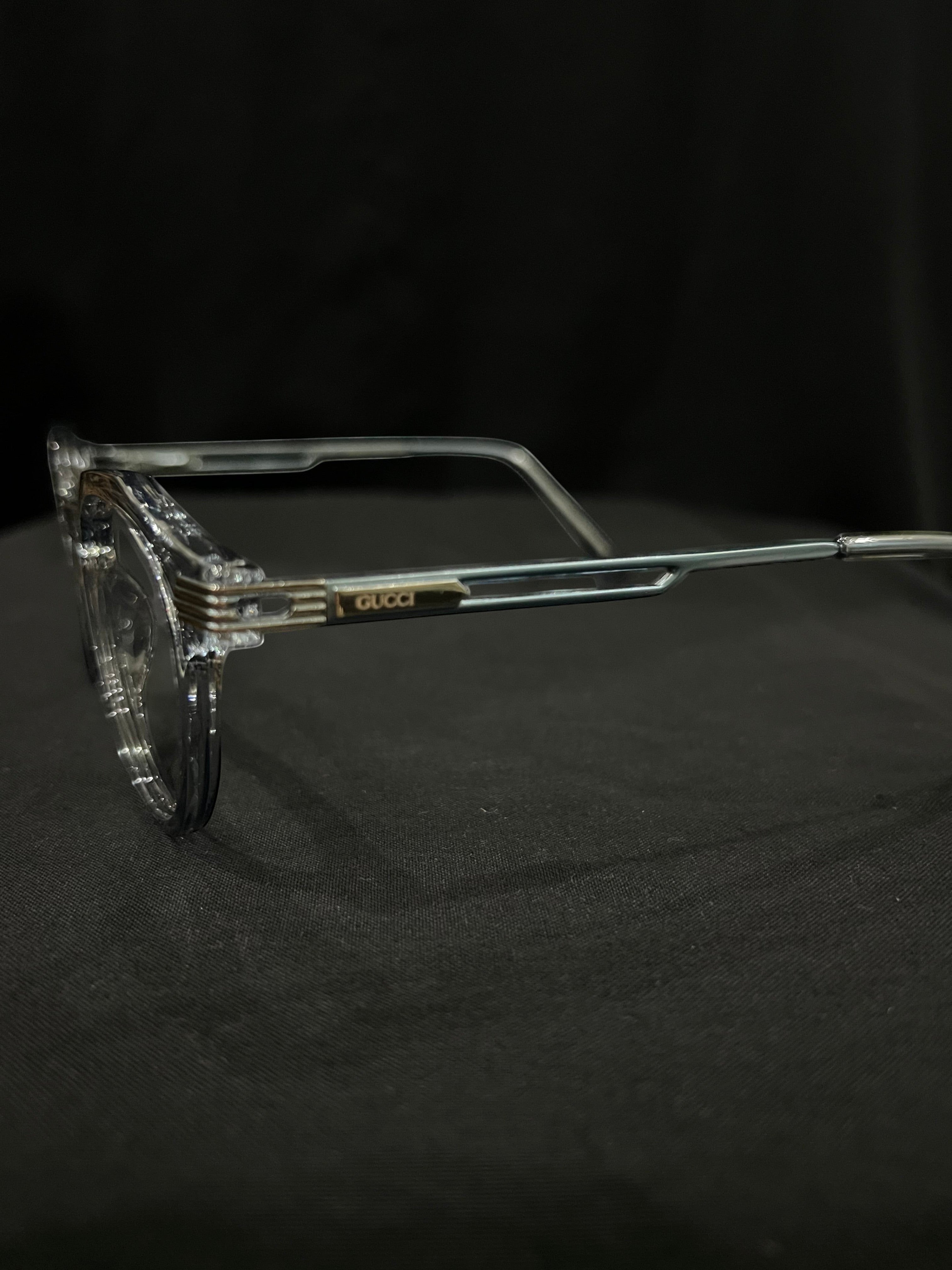 OPTICA Kocka round clear plastic frames with black kitty corner details and Gucci logo on the temple.