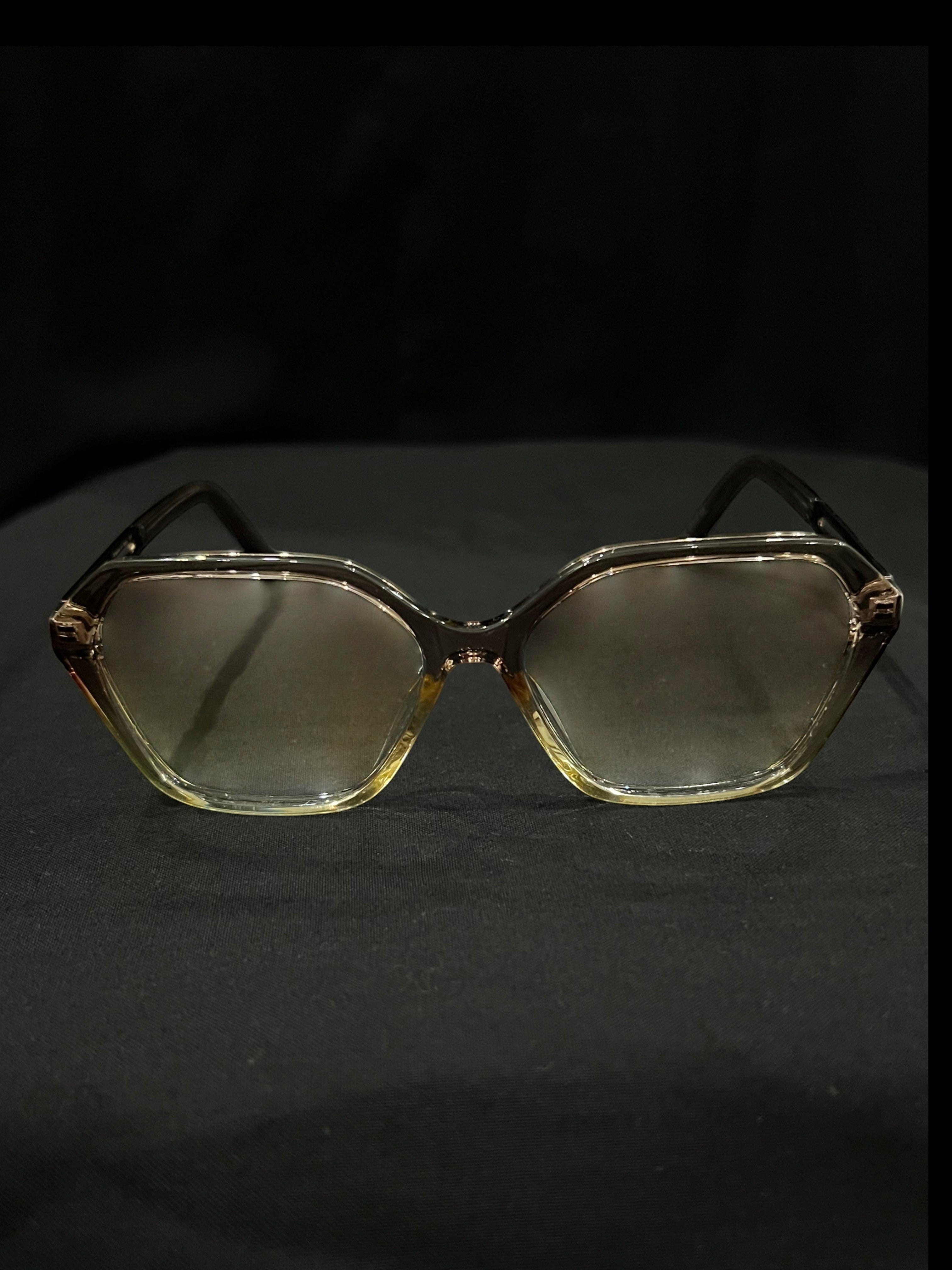 OPTICA geometric octagonal eyeglasses in translucent light brown acetate with angular frames and gradient lenses.