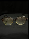 OPTICA geometric octagonal eyeglasses in translucent light brown acetate with gradient lenses.
