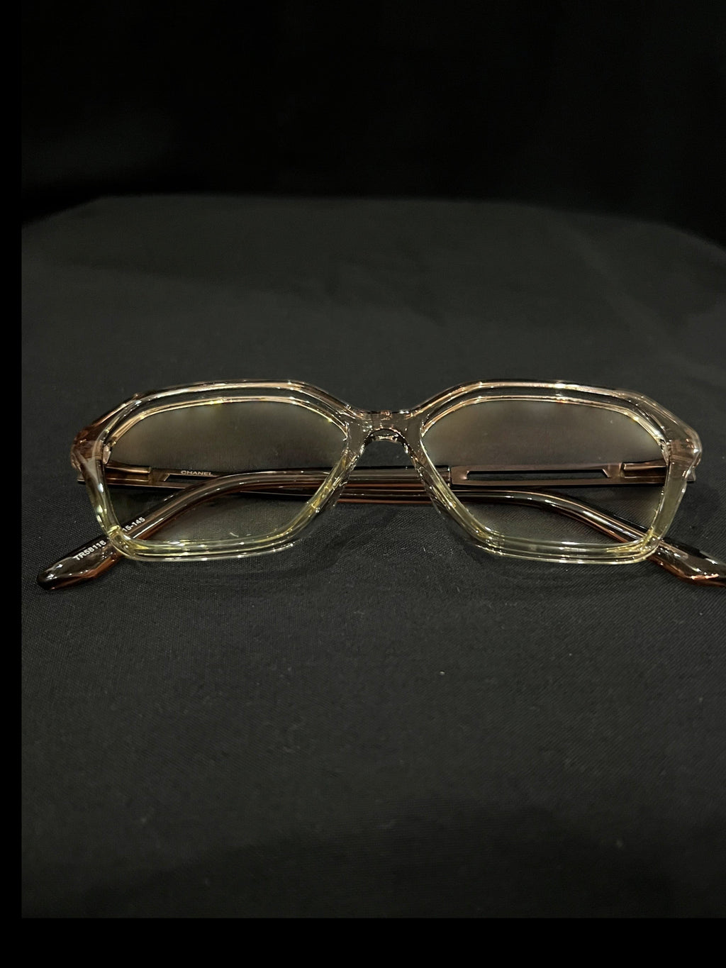 OPTICA geometric octagonal eyeglasses in translucent light brown acetate with angular frames and subtle brown lenses.