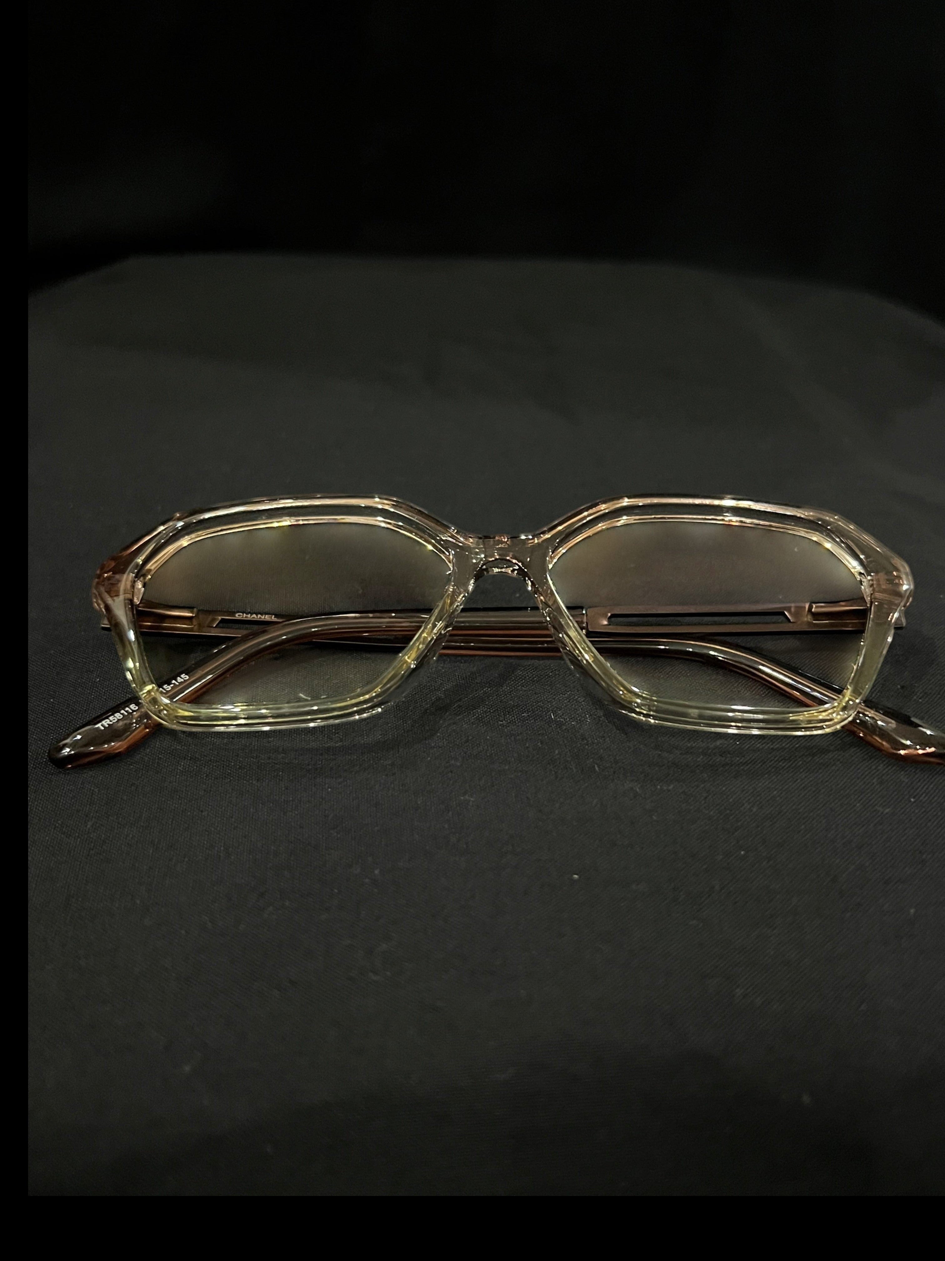 OPTICA geometric octagonal eyeglasses in translucent light brown acetate with angular frames and subtle brown lenses.
