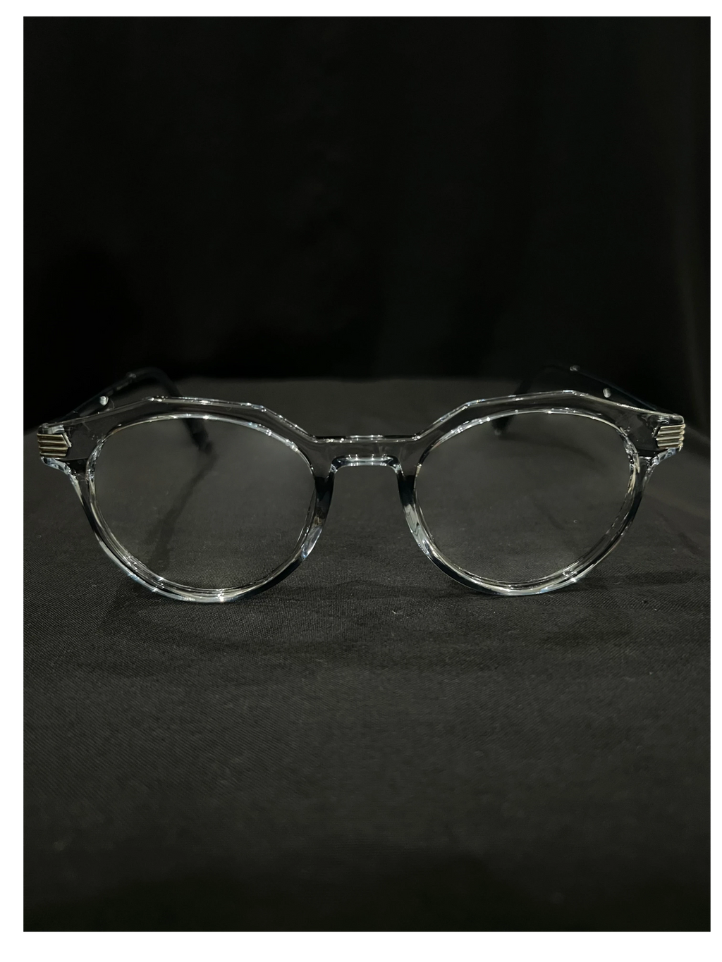 OPTICA Kocka round clear plastic eyeglasses with black kitty corner details. Suitable for medium to heavy faces.